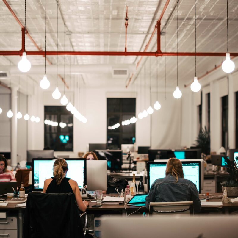 People working at computers in a large office space